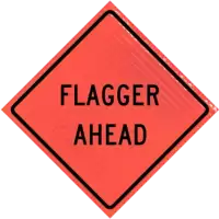 flagger ahead warning sign for road work